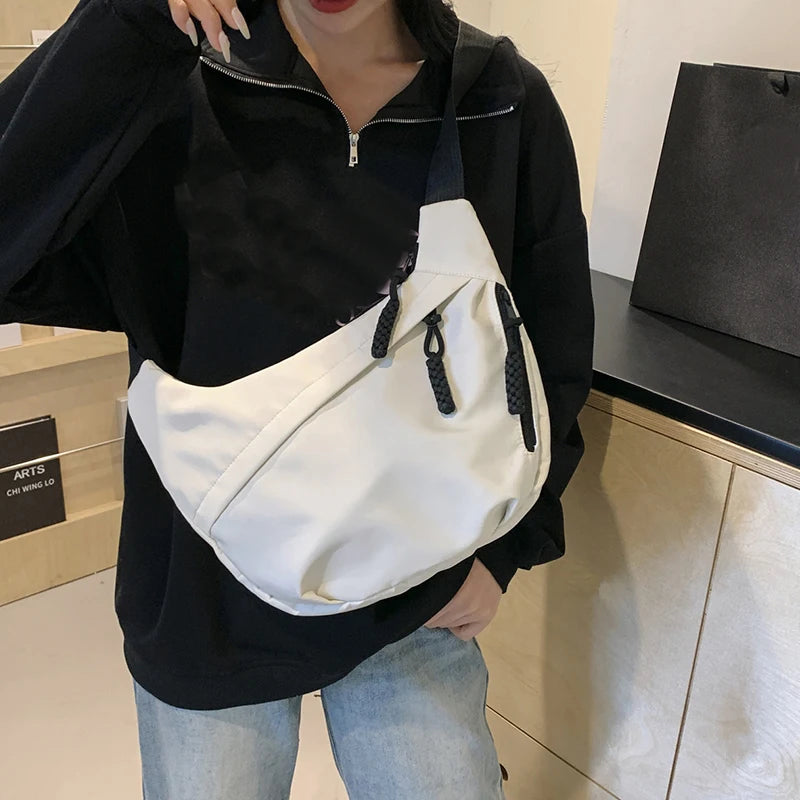 Neutral style tote bag with strap for carrying fitness items. New mini street-style handbag with shoulder strap. Lightweight and